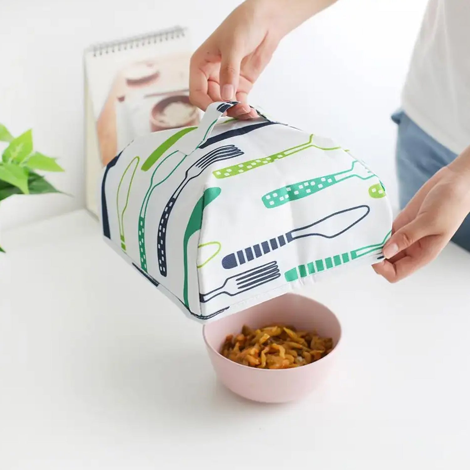 Foldable food cover to protect dishes from dust and insects, perfect for picnics.